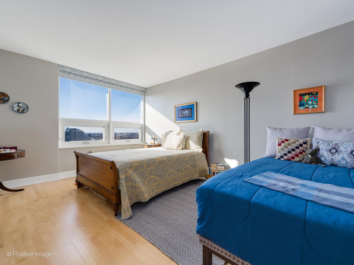 5733 North Sheridan Road, Unit 22C Chicago, IL 60660 - Photo 16 of 29 a bedroom with two beds and a dresser