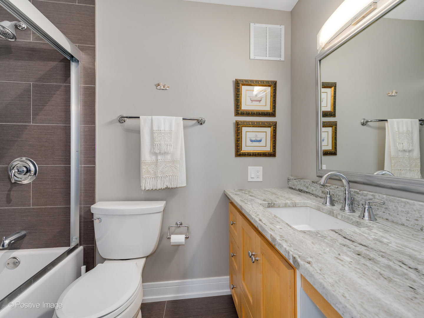 5733 North Sheridan Road, Unit 22C Chicago, IL 60660 - Photo 18 of 29 a bathroom with a granite countertop toilet sink and mirror