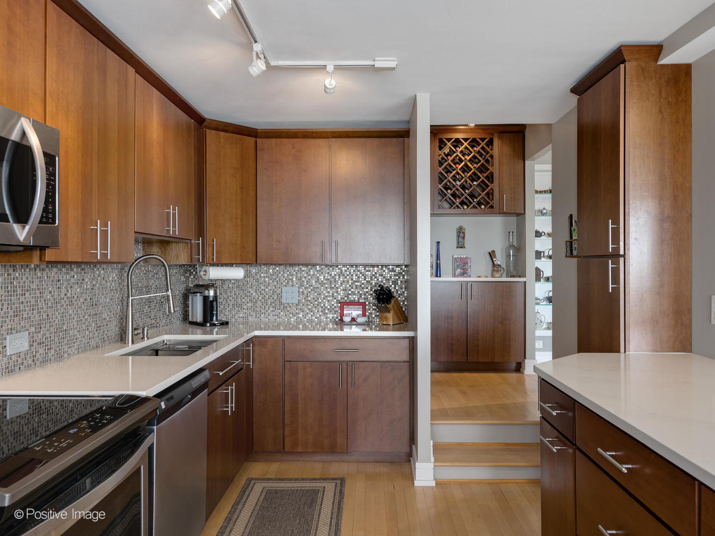 5733 North Sheridan Road, Unit 22C Chicago, IL 60660 - Photo 8 of 29 a kitchen with stainless steel appliances granite countertop a refrigerator a sink and a stove