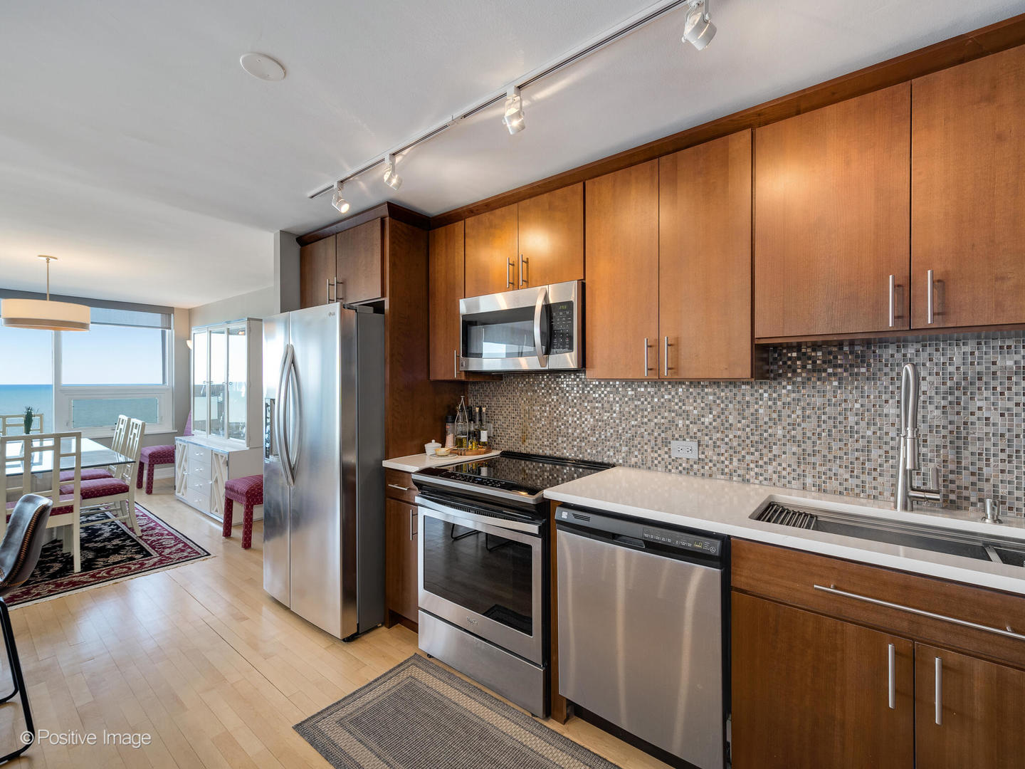 5733 North Sheridan Road, Unit 22C Chicago, IL 60660 - Photo 9 of 29 a kitchen with a sink stove and refrigerator