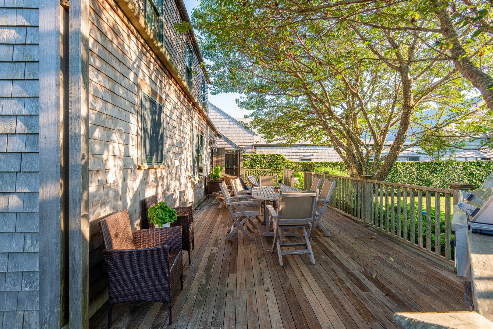 41.5 Nobadeer Farm Road Nantucket, MA 02554 - Photo 7 of 36 a view of a roof deck with table and chairs and wooden floor