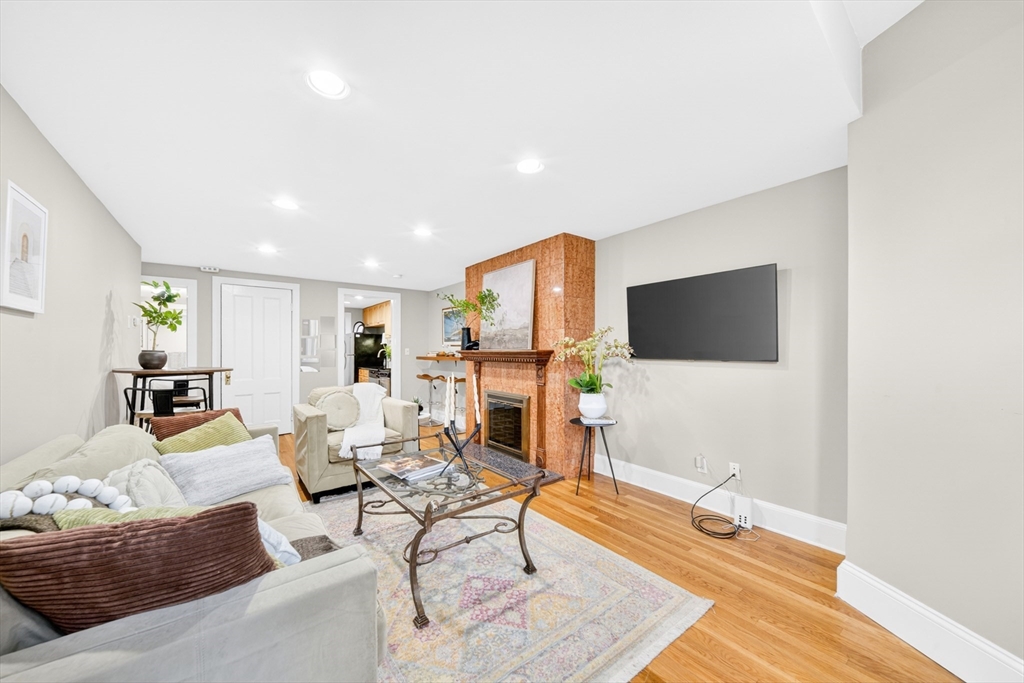 352 Tappan Street, Unit 1 Brookline, MA 02445 - Photo 9 of 42 a living room with furniture and a flat screen tv