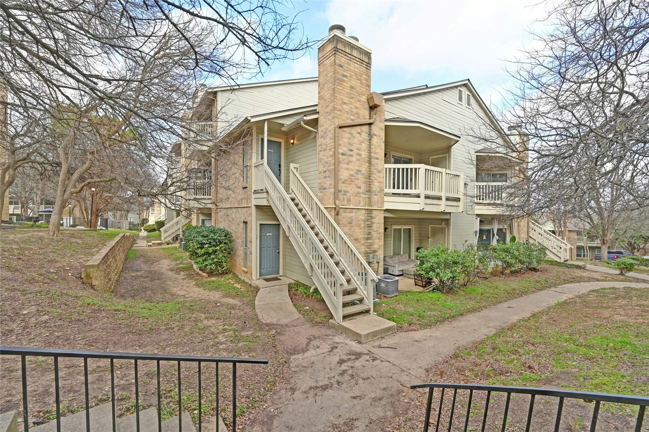 2450 Wickersham Lane, Unit 710 Austin, TX 78741 - Photo 2 of 20 a front view of a house with a yard