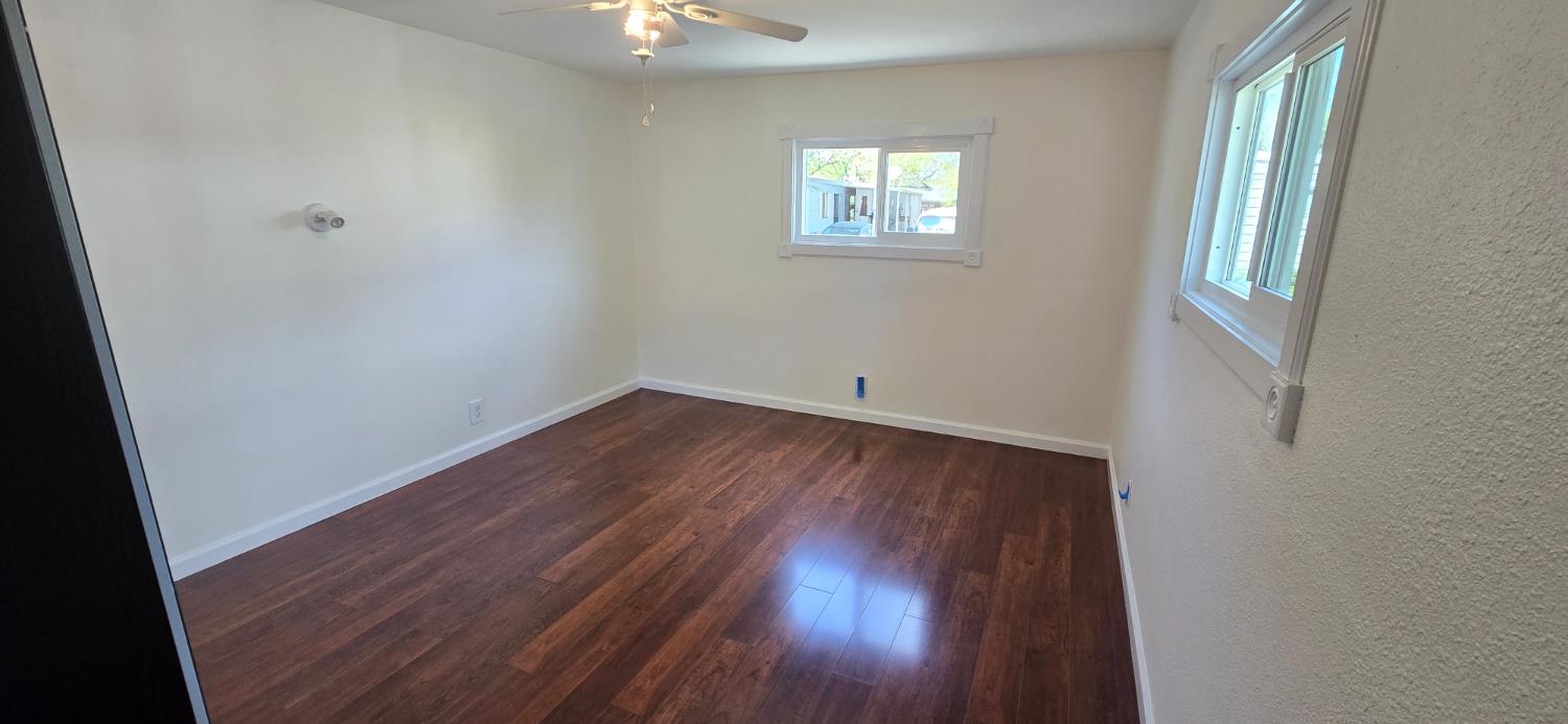 189 Full Circle Davis, CA 95618 - Photo 15 of 29 an empty room with wooden floor and windows