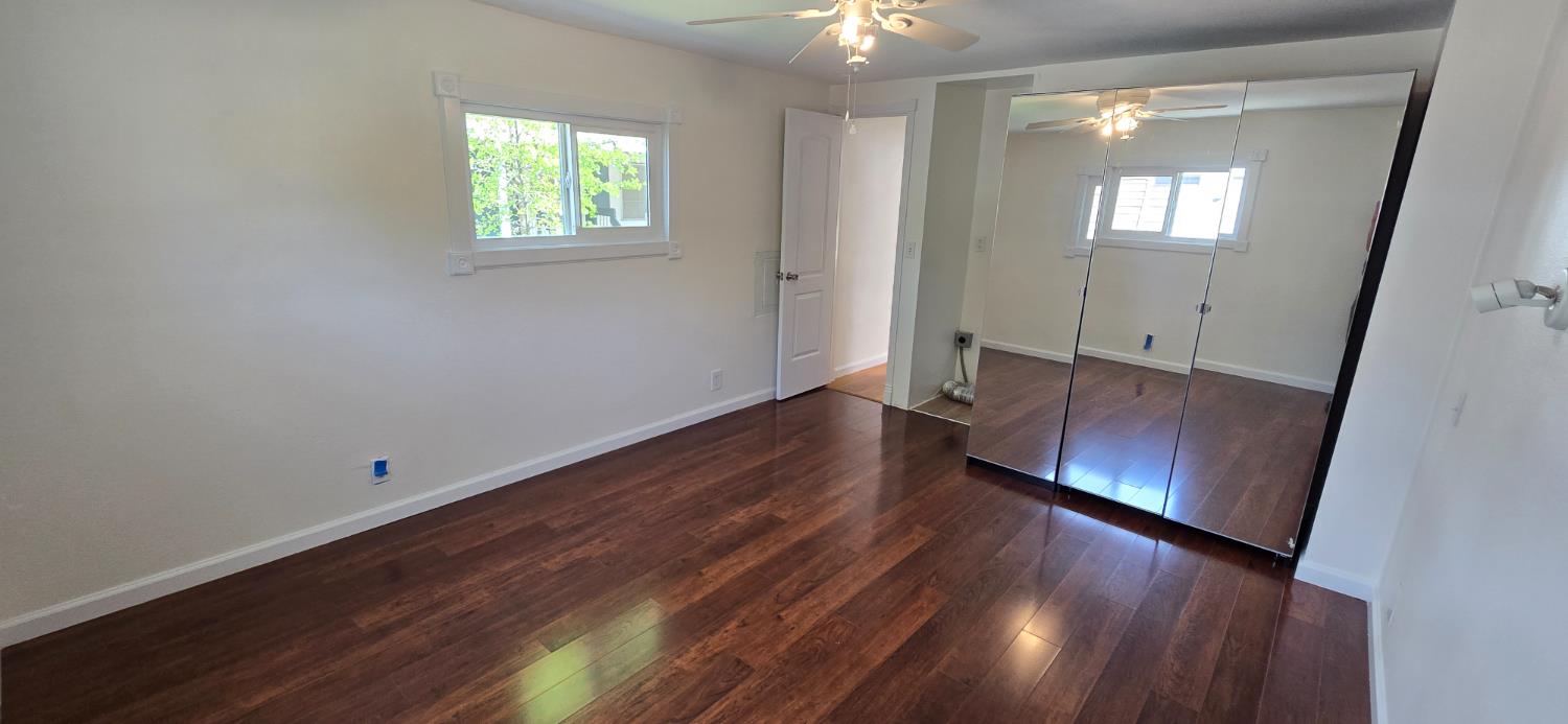189 Full Circle Davis, CA 95618 - Photo 16 of 29 an empty room with wooden floor and windows