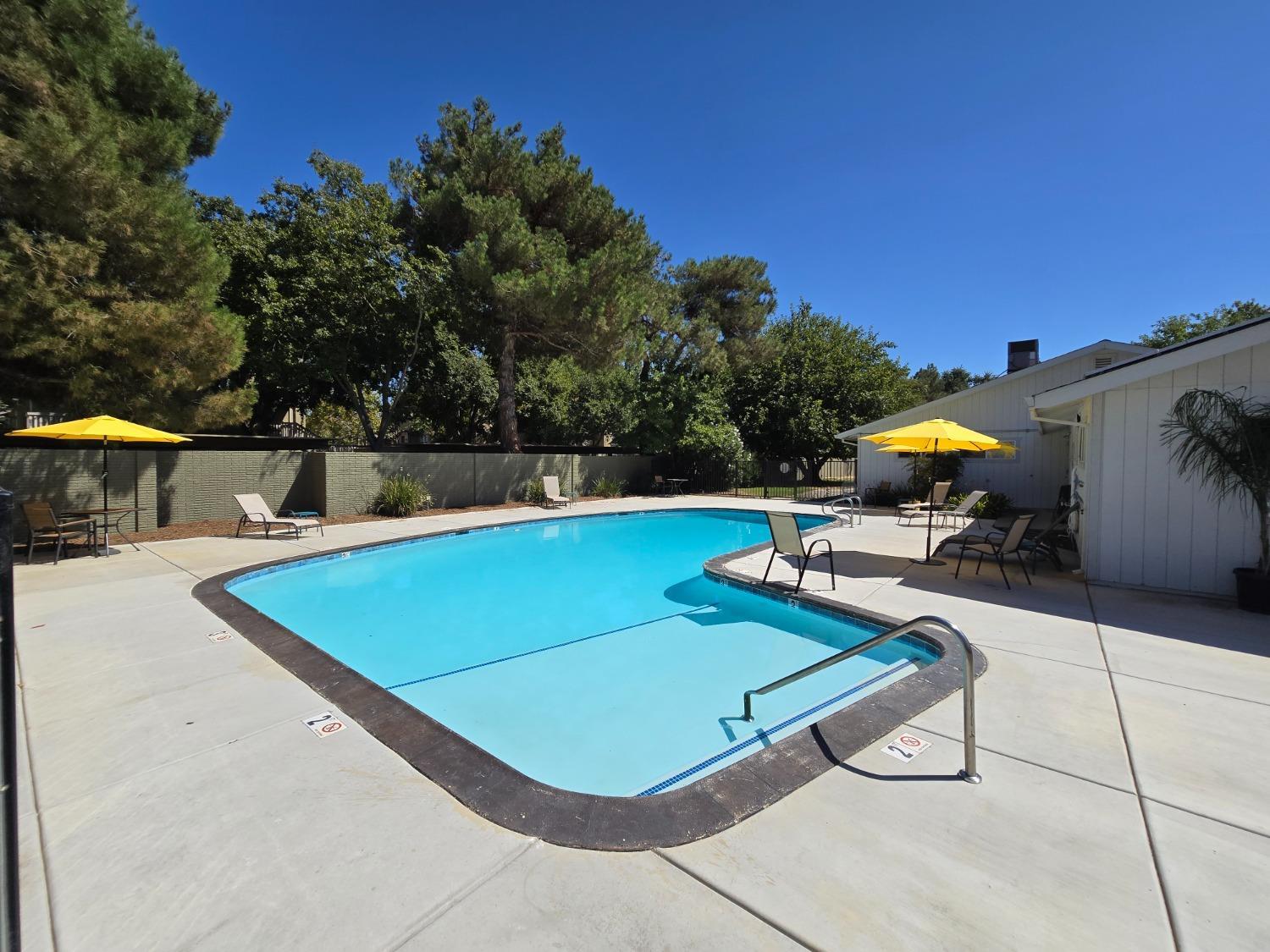 189 Full Circle Davis, CA 95618 - Photo 29 of 29 a view of a swimming pool with a chair and tables