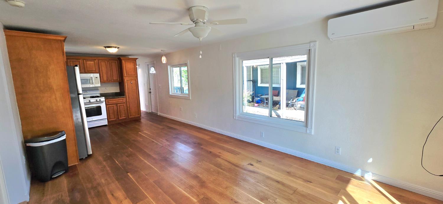 189 Full Circle Davis, CA 95618 - Photo 3 of 29 a view of an empty room with a window and wooden floor