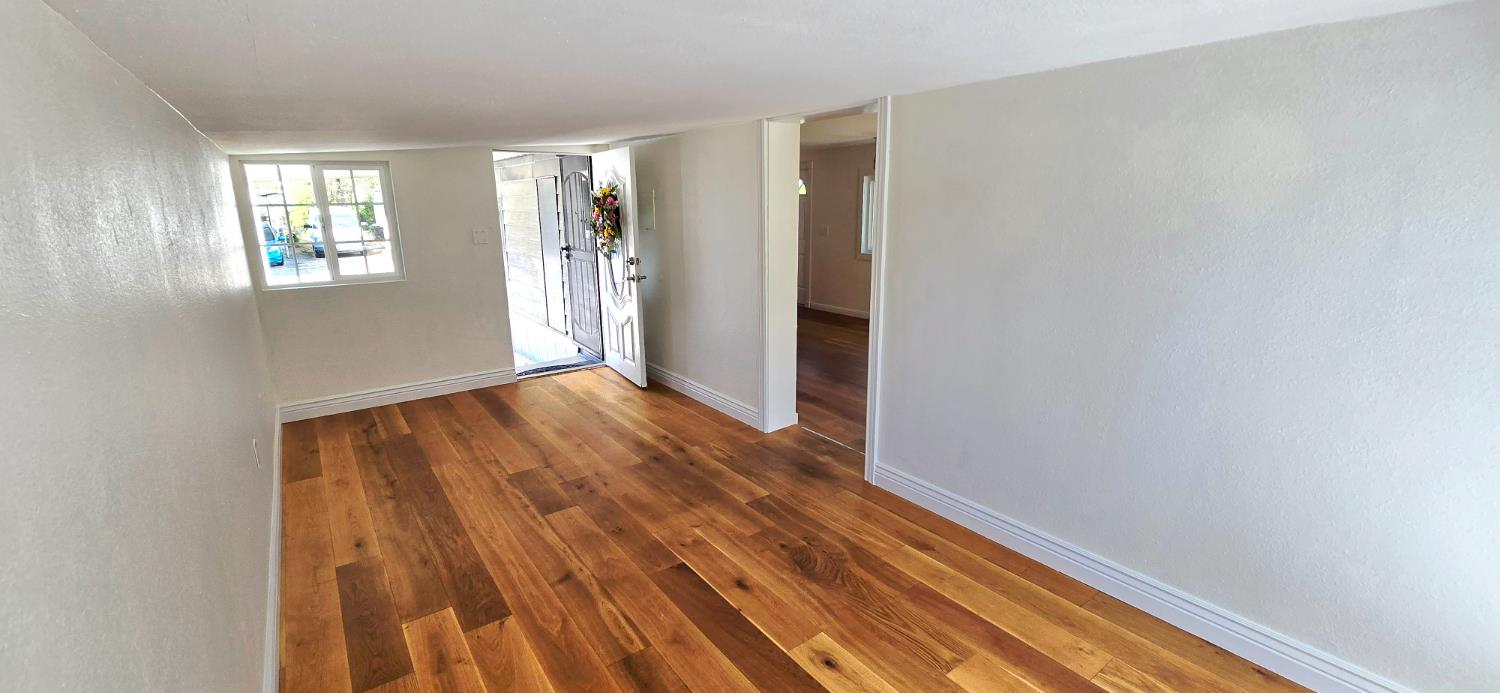 189 Full Circle Davis, CA 95618 - Photo 8 of 29 a view of an empty room with wooden floor and a window
