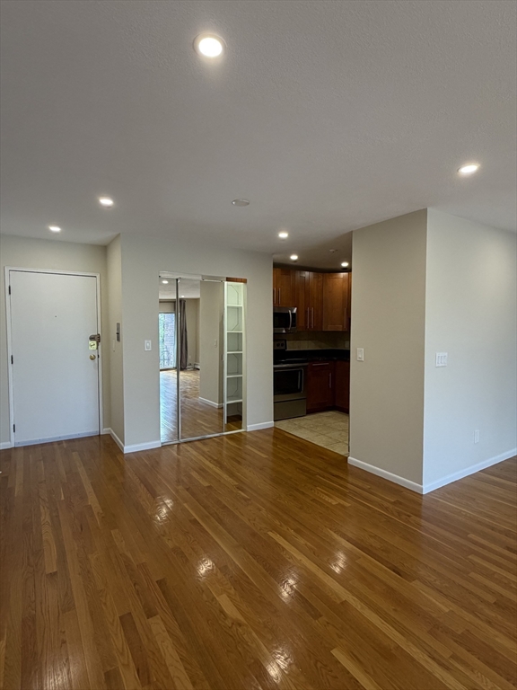 383 Langley Road, Unit 11 Newton, MA 02459 - Photo 5 of 15 a view of an empty room with a kitchen