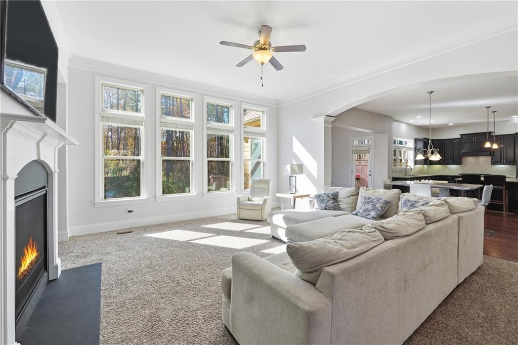 4409 Talisker Lane Acworth, GA 30101 - Photo 13 of 61 a living room with furniture a fireplace and a flat screen tv
