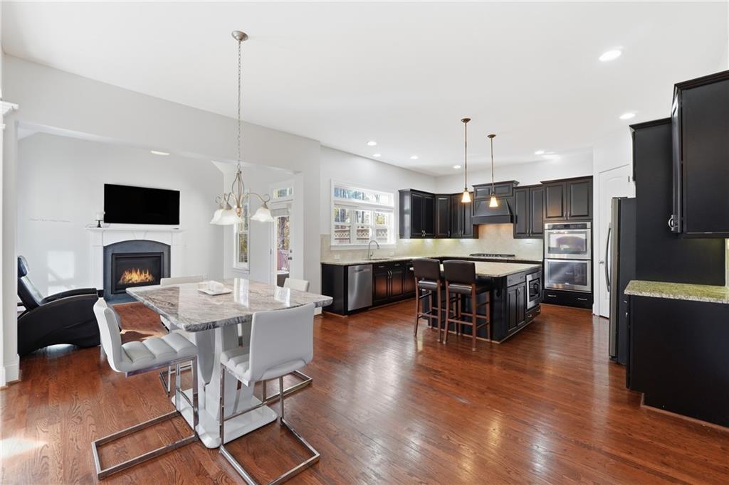 4409 Talisker Lane Acworth, GA 30101 - Photo 15 of 61 a living room with furniture a fireplace a flat screen tv and kitchen view
