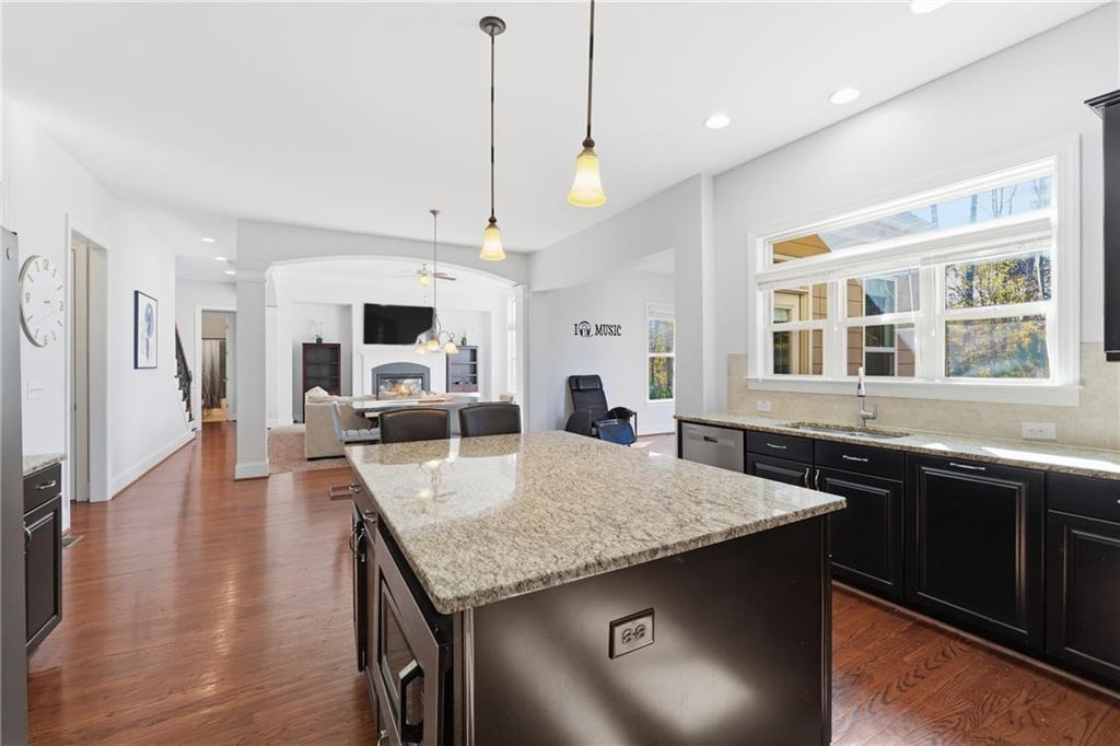 4409 Talisker Lane Acworth, GA 30101 - Photo 18 of 61 a kitchen with granite countertop a stove a sink and a refrigerator