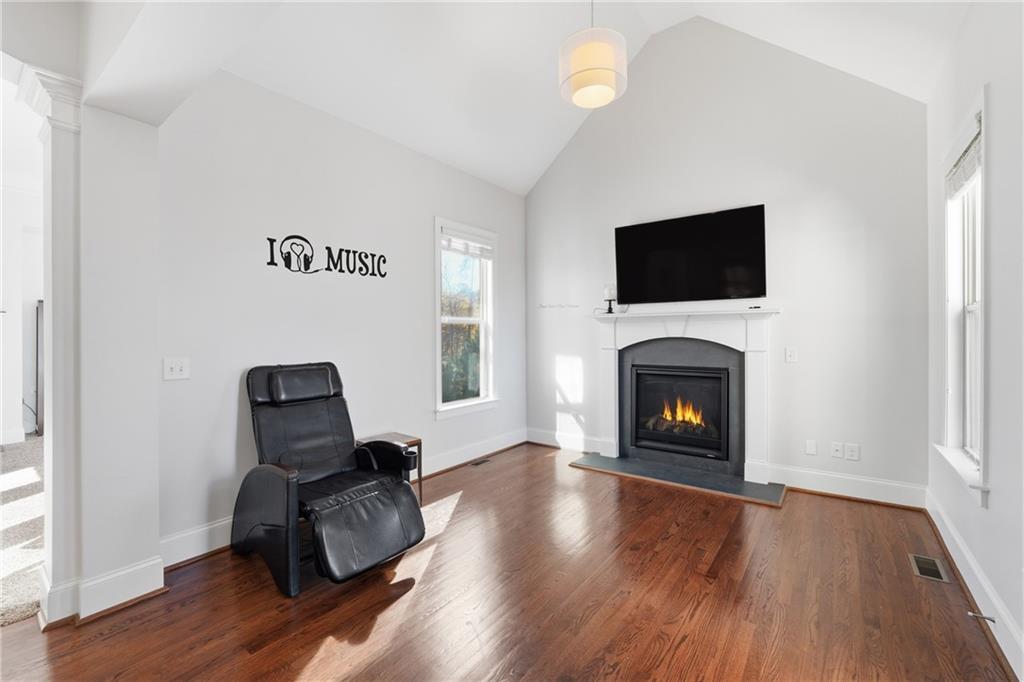 4409 Talisker Lane Acworth, GA 30101 - Photo 20 of 61 a living room with furniture a flat screen tv and a fireplace