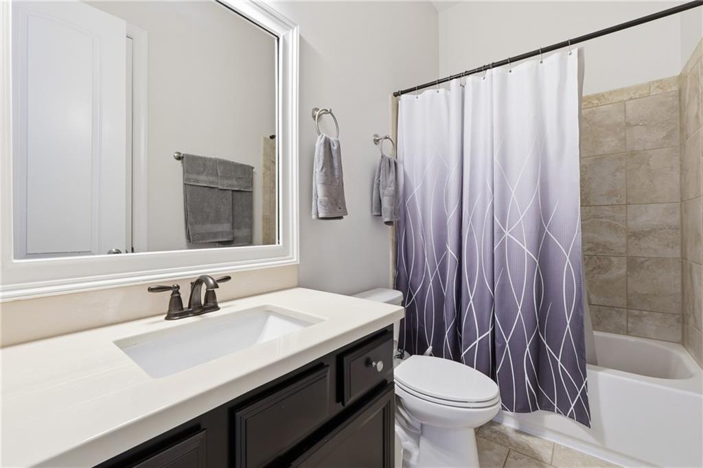 4409 Talisker Lane Acworth, GA 30101 - Photo 25 of 61 a bathroom with a sink a toilet and a mirror