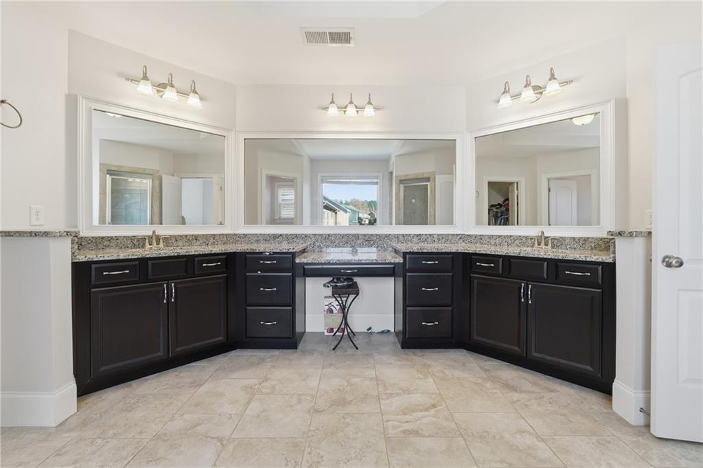 4409 Talisker Lane Acworth, GA 30101 - Photo 30 of 61 a spacious bathroom with a granite countertop double vanity and a mirror