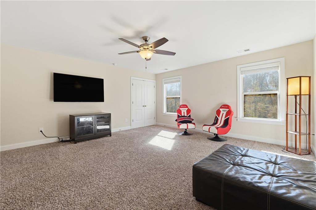 4409 Talisker Lane Acworth, GA 30101 - Photo 37 of 61 a living room with furniture a flat screen tv and a window