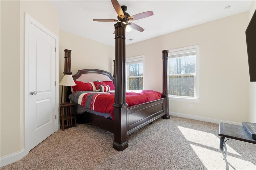 4409 Talisker Lane Acworth, GA 30101 - Photo 39 of 61 a bed room with a bed and a chandelier