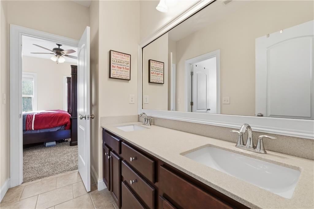 4409 Talisker Lane Acworth, GA 30101 - Photo 40 of 61 a en suite bathroom with a double vanity sink and a mirror