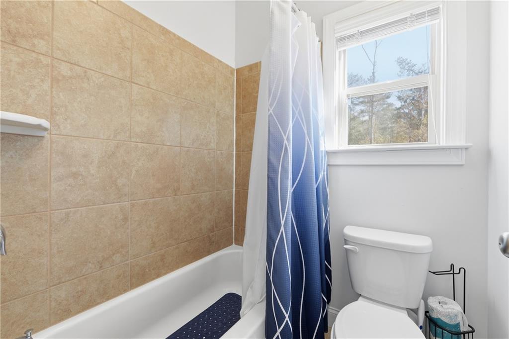 4409 Talisker Lane Acworth, GA 30101 - Photo 41 of 61 a white toilet sitting next to a bathroom sink