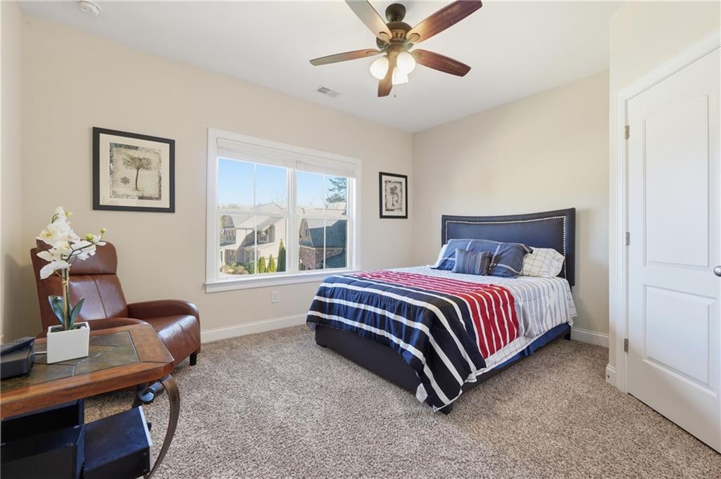 4409 Talisker Lane Acworth, GA 30101 - Photo 42 of 61 a spacious bedroom with a bed and a desk