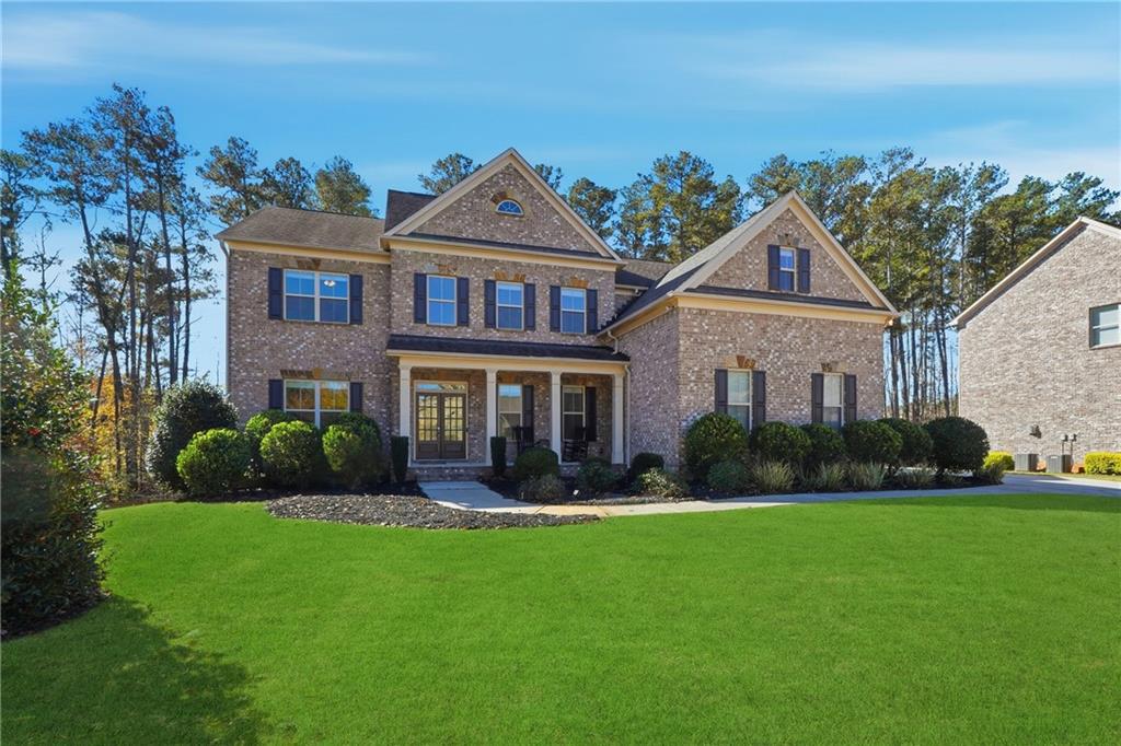 4409 Talisker Lane Acworth, GA 30101 - Photo 55 of 61 a front view of a house with a yard and potted plants