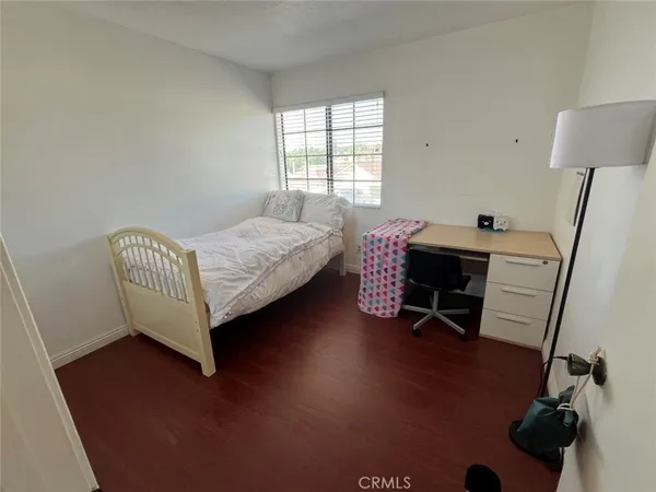 a bedroom with bed and a window