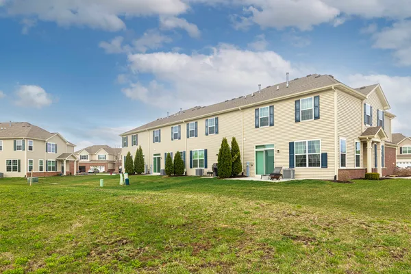 a front view of a building with a garden