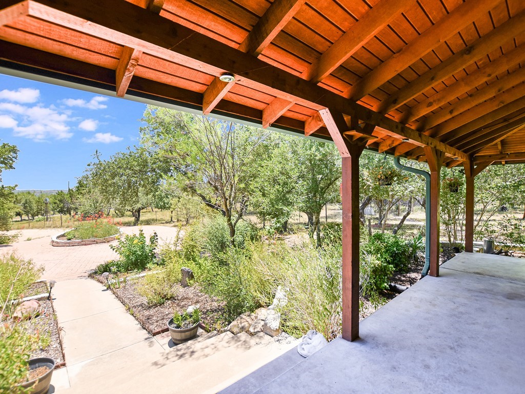 254 Middleton Road Spicewood, TX 78669 - Photo 3 of 32 a backyard of a house with a garden and plants