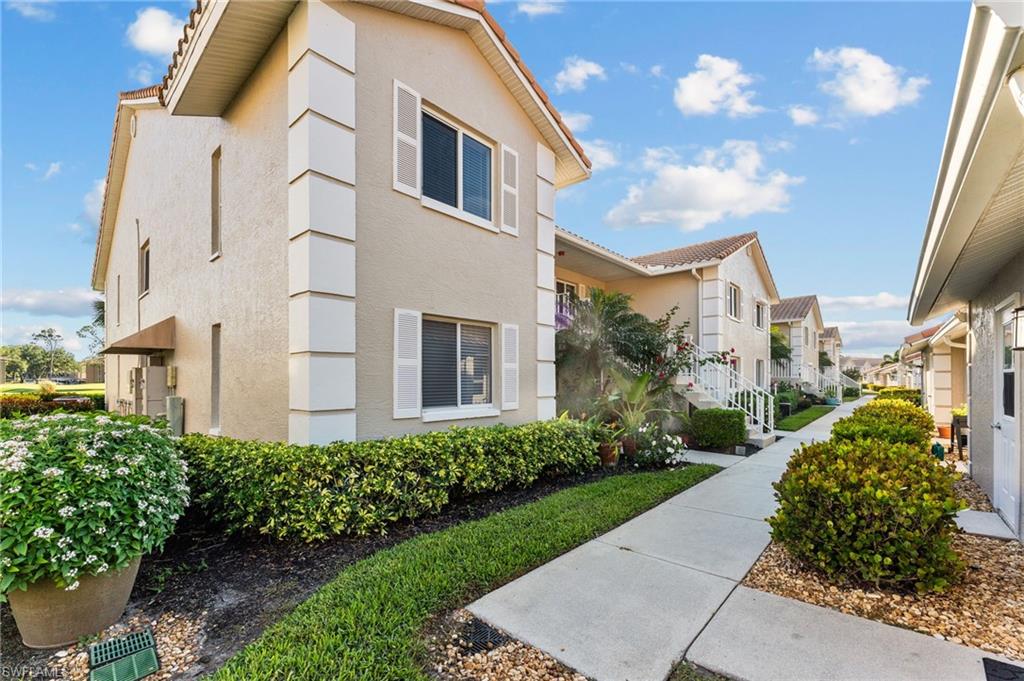 5928 Cranbrook Way, Unit D202 Naples, FL 34112 - Photo 23 of 23 View of home's exterior featuring stucco siding and a residential view