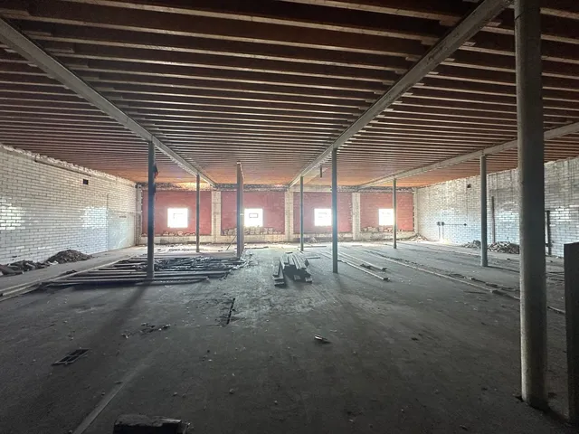 a view of a patio with table and chairs and floor to ceiling window