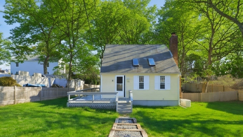 a front view of house with a garden