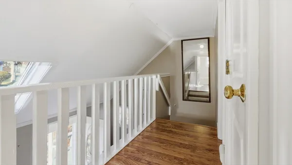 a view of hallway with wooden floor
