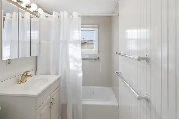 a bathroom with a sink a mirror and a shower