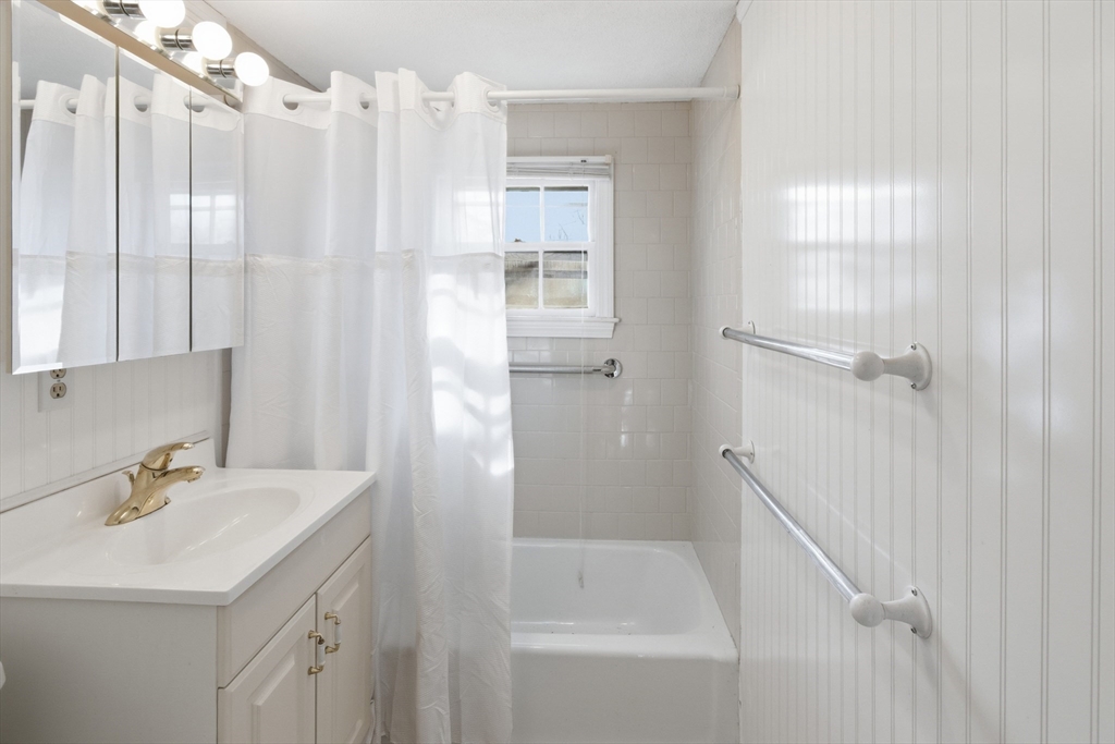 292 Megan Road Barnstable, MA 02601 - Photo 8 of 12 a bathroom with a sink a mirror and a shower