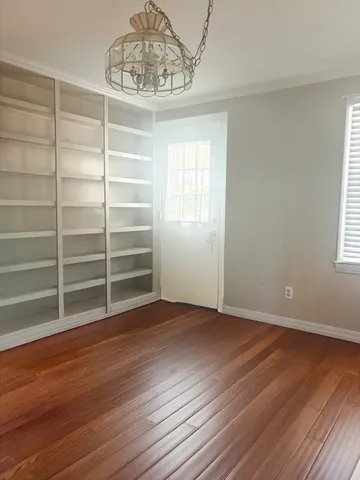 a view of a room with wooden floor and a window