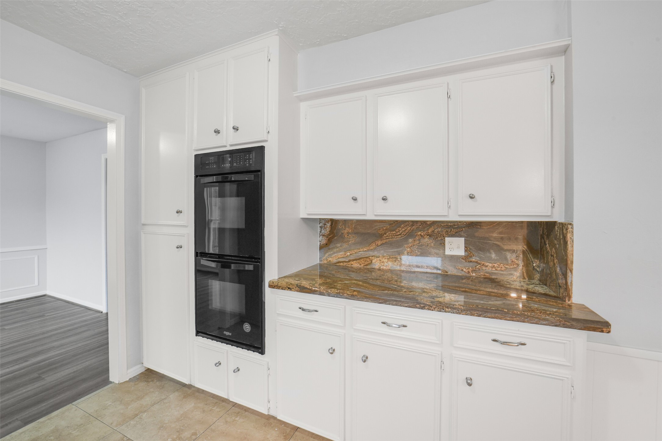 7611 Theisswood Road Spring, TX 77379 - Photo 14 of 41 a kitchen with granite countertop white cabinets and stainless steel appliances
