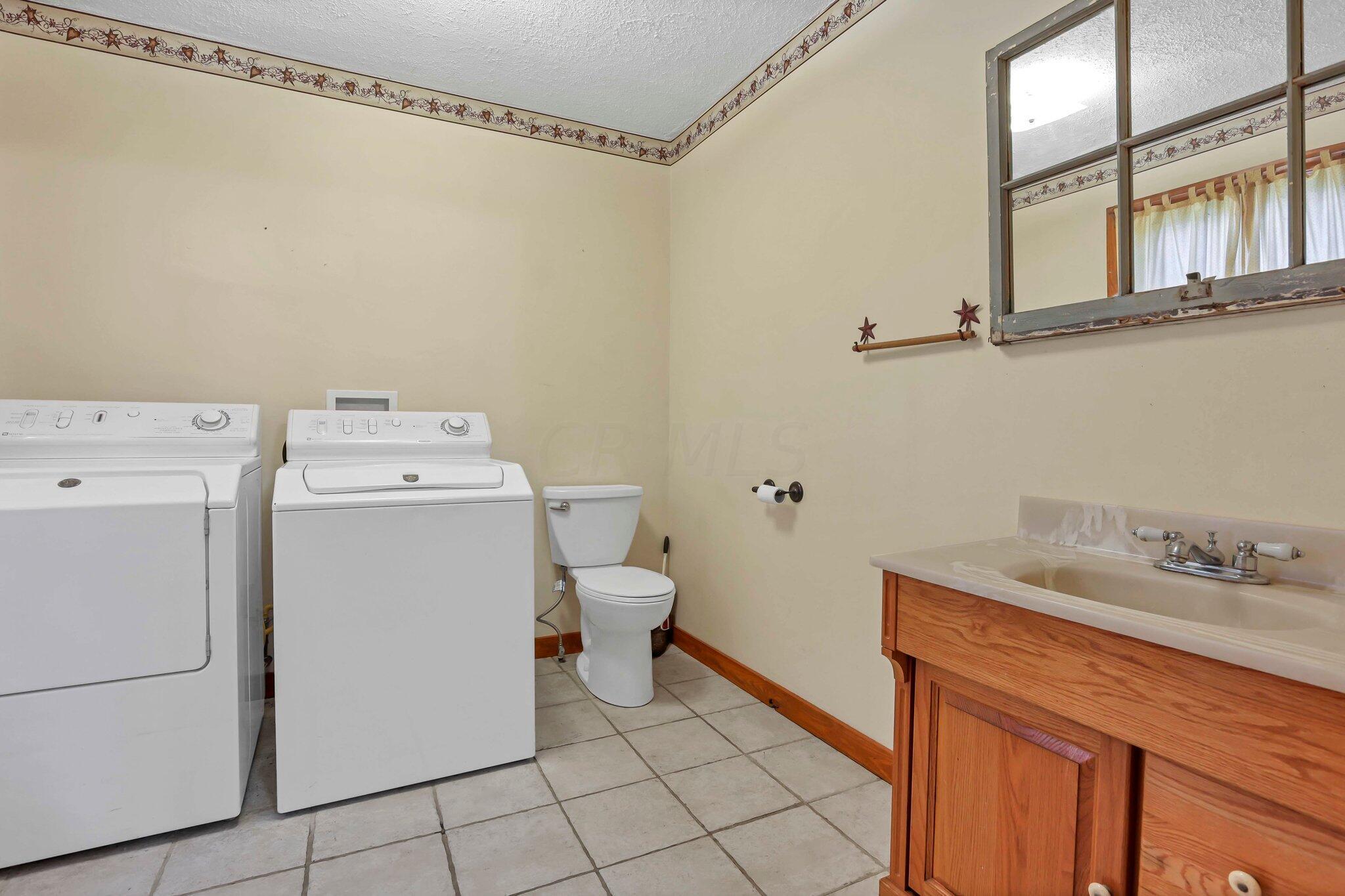 5225 Deeds Road Southwest Pataskala, OH 43062 - Photo 14 of 43 1st floor laundry & 1/2 bath
