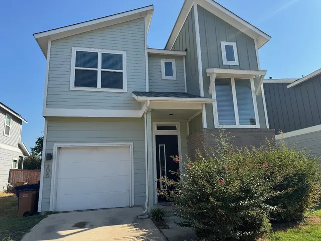 a view of a house with many windows and plants