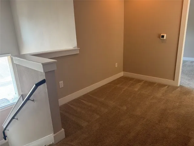 a backyard of a house with large trees and wooden fence