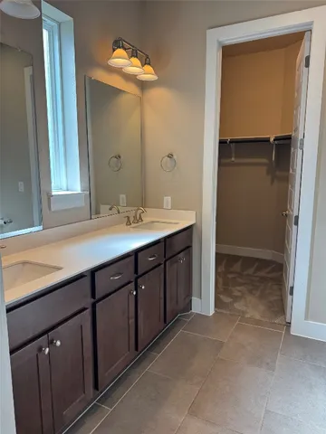 a spacious bathroom with a double vanity sink and a mirror