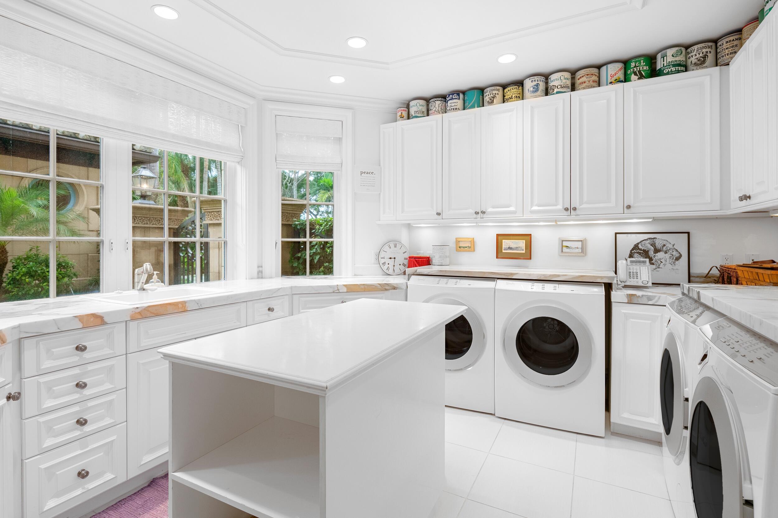 372 Regatta Drive Jupiter, FL 33477 - Photo 59 of 93 a kitchen with a white stove top oven and white cabinets with wooden floor
