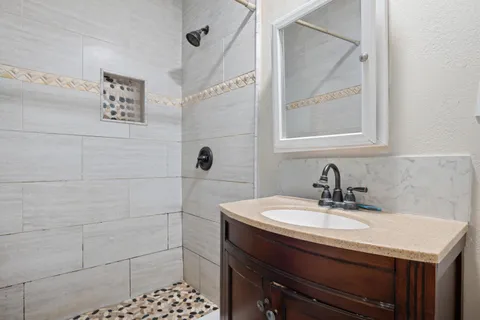 a bathroom with a sink a vanity and a mirror