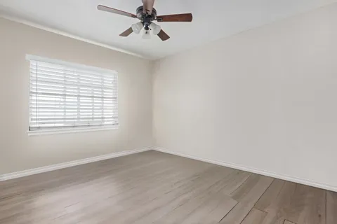 a view of a room with wooden floor and windows