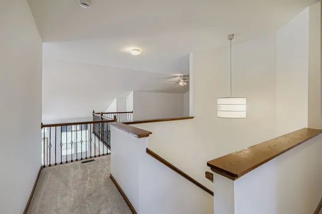 a view of a hallway with stairs