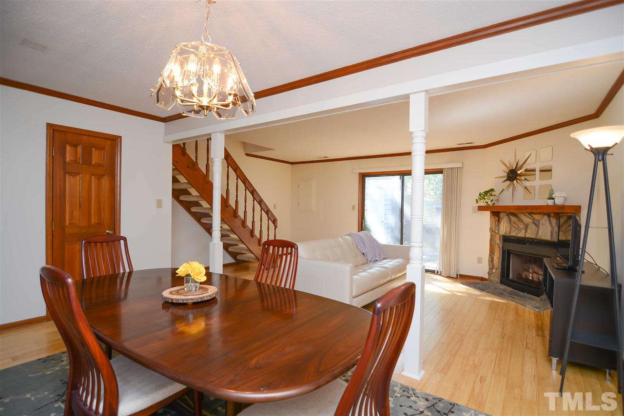 5433 Pine Top Circle Raleigh, NC 27612 - Photo 11 of 23 a view of a dining room with furniture a chandelier and wooden floor