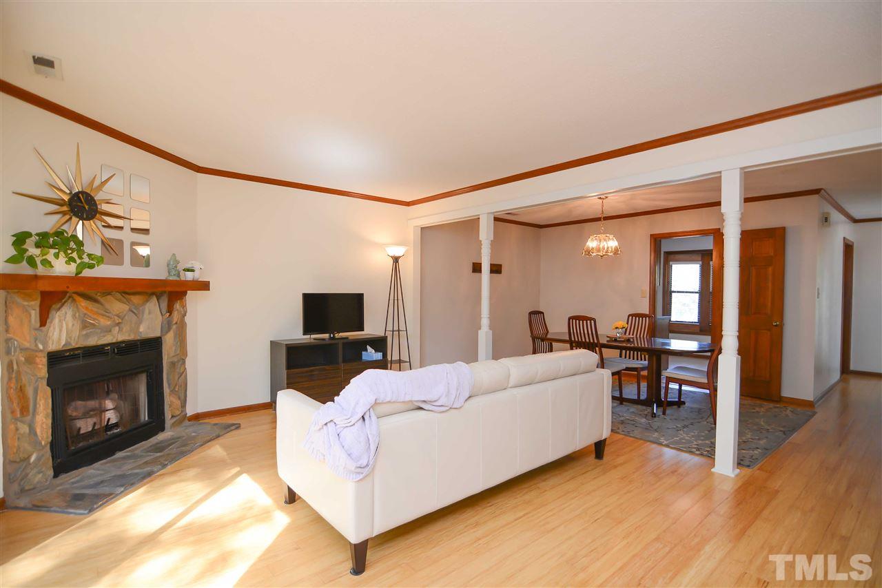 5433 Pine Top Circle Raleigh, NC 27612 - Photo 12 of 23 a spacious bedroom with a bed and a fireplace