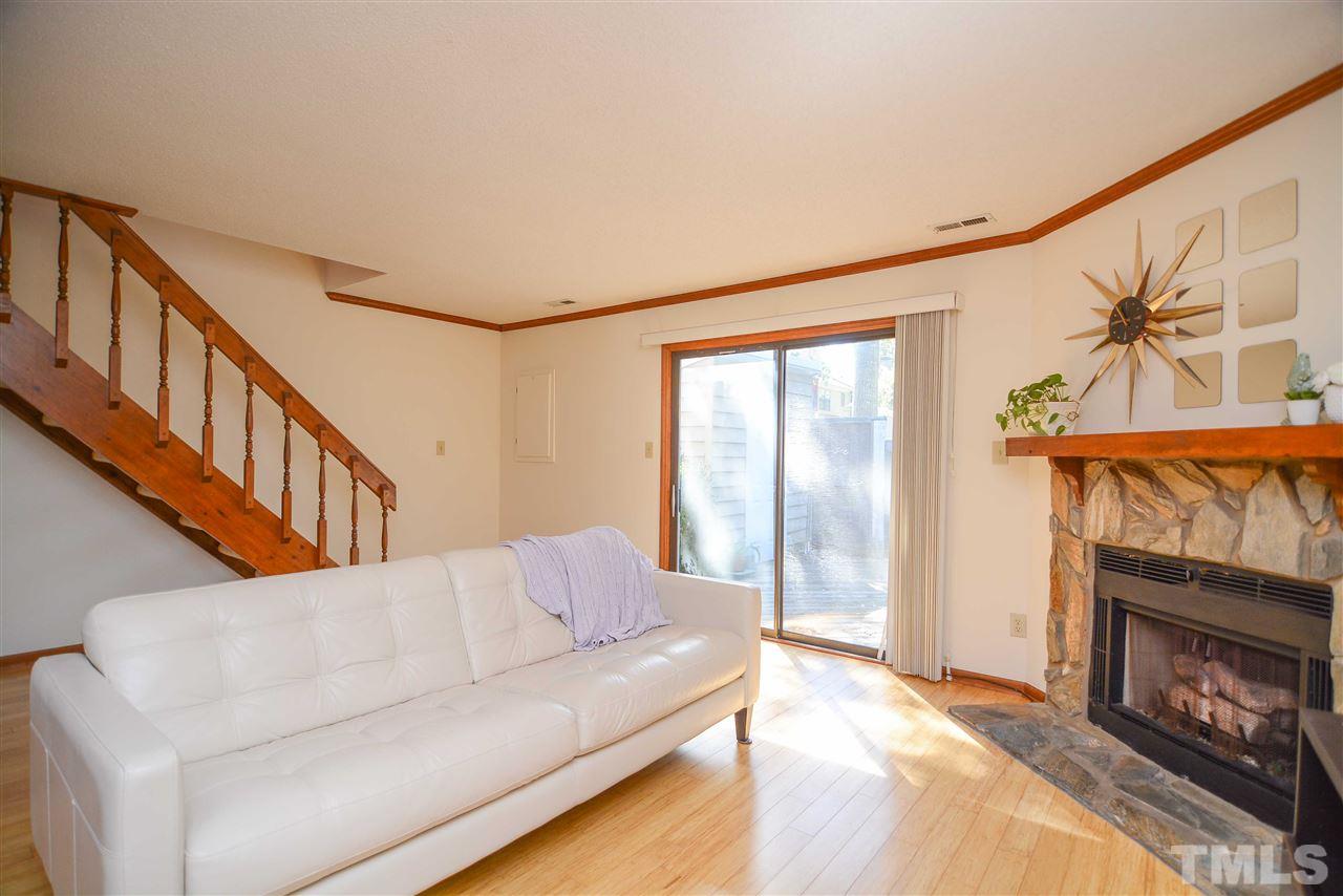 5433 Pine Top Circle Raleigh, NC 27612 - Photo 14 of 23 a living room with fireplace furniture and a floor to ceiling window