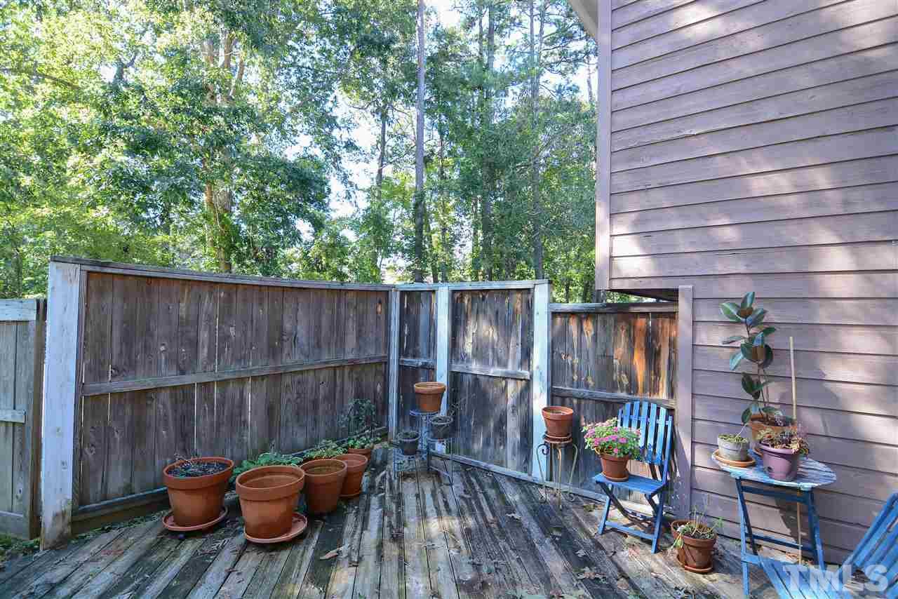 5433 Pine Top Circle Raleigh, NC 27612 - Photo 5 of 23 a view of a deck with wooden chairs and a fire pit