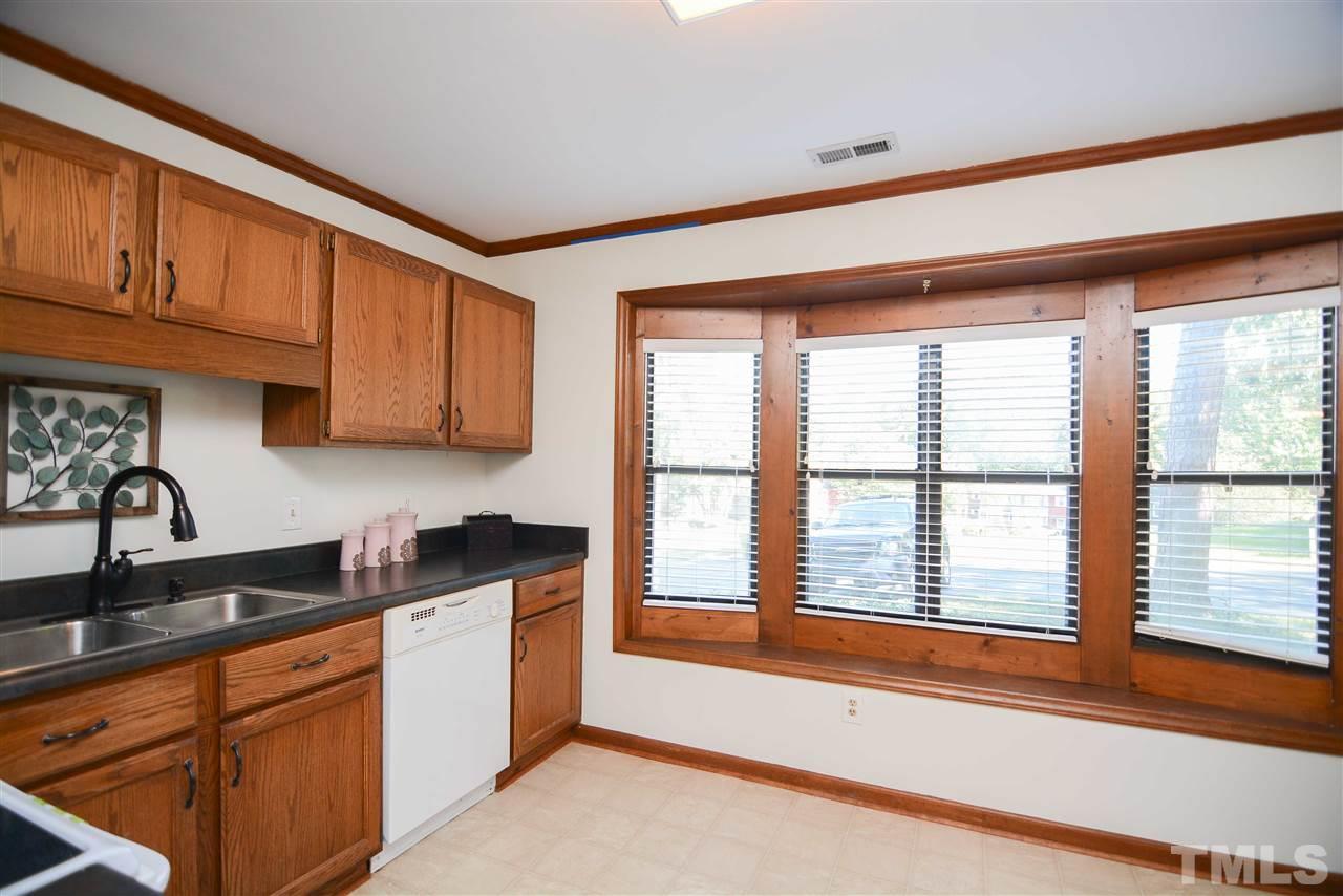 5433 Pine Top Circle Raleigh, NC 27612 - Photo 8 of 23 a kitchen with stainless steel appliances granite countertop a sink a stove and a microwave