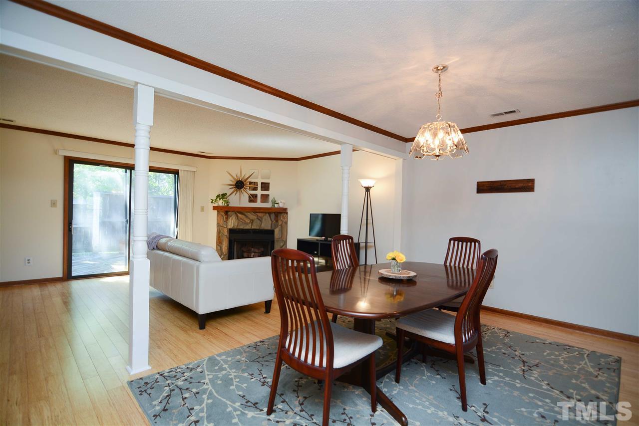 5433 Pine Top Circle Raleigh, NC 27612 - Photo 10 of 23 a view of a dining room with furniture wooden floor and chandelier